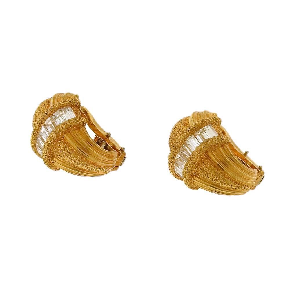 18K yellow gold Buccellati clip-on shrimp style earrings set at center with diamond baguettes and stipple-textured by hand in the Buccellati workroom. Earrings measure 5/8