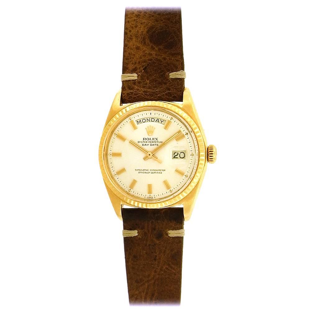 18K yellow gold Rolex  Oyster Perpetual, Day-Date, Ref. 1803, circa 1968, is a vintage tonneau-shaped, center seconds, self-winding, water-resistant, 18K yellow gold wristwatch with day & date. The 36mm case has a fluted bezel, screwed-down case