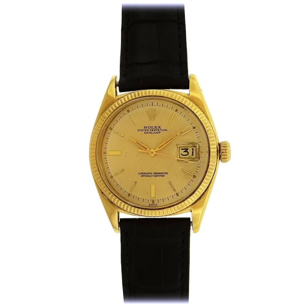 18K yellow gold Rolex, Ref. 1601 DateJust circa 1971, is a classic automatic water-resistant, tonneau-shaped, 18K yellow gold Datejust with Rolex 18K buckle. The 36mm case has a screwed-down and crown, reeded bezel, and crystal with cyclops lens. 