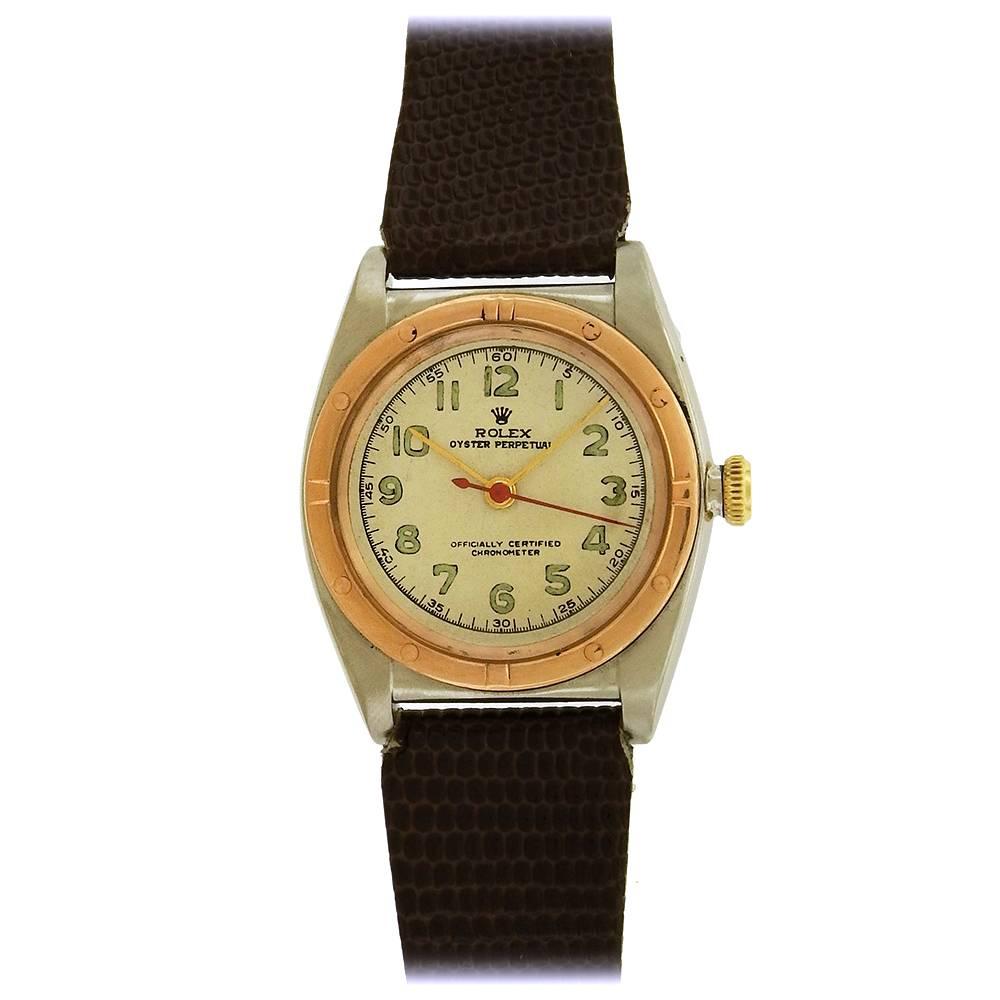 Two-tone stainless steel and rose gold  Rolex Oyster Perpetual, Chronometer, Ref. 2940, circa 1950's, is a vintage, tonneau-shaped, center seconds, self-winding, water resistant, stainless steel wristwatch.  The 32mm case has a rose gold bezel with