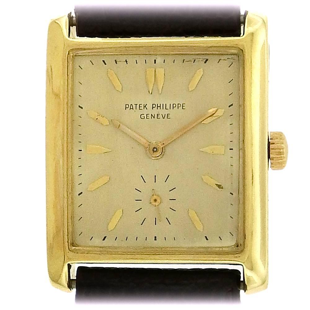 18K yellow gold Patek Philippe, Ref. 2530, circa late 1950's, is a rare rectangular, 18K yellow gold wristwatch.  The 27mm x 35mm rectangular case has a snapback and  straight lugs, the silver dial features applied yellow gold faceted baton and dart