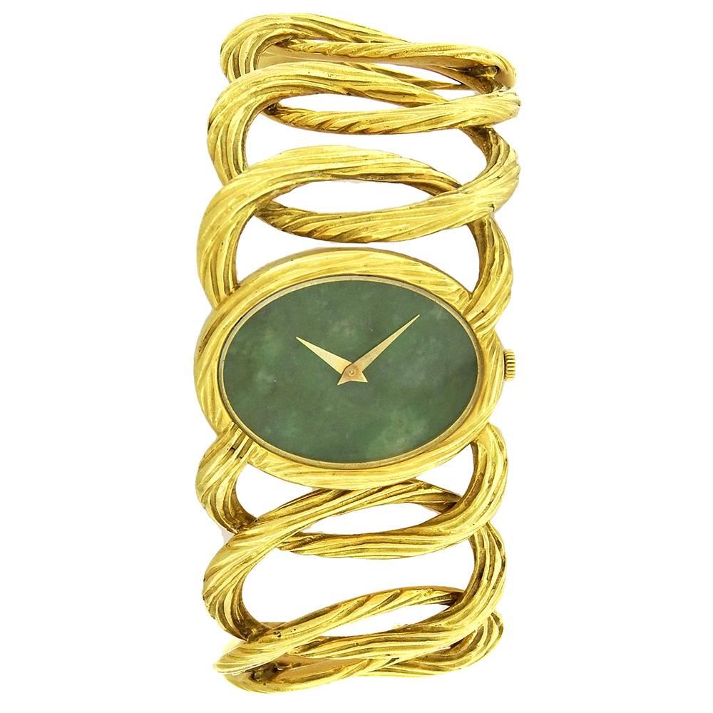 18K yellow gold Piaget bracelet watch, made circa 1980, reference 9852D65, is an elegant, 18K yellow gold bracelet watch with jade dial and integral 18K yellow gold Piaget bracelet. The 32mm x 25mm oval case has a screwed-down back, chased bezel to