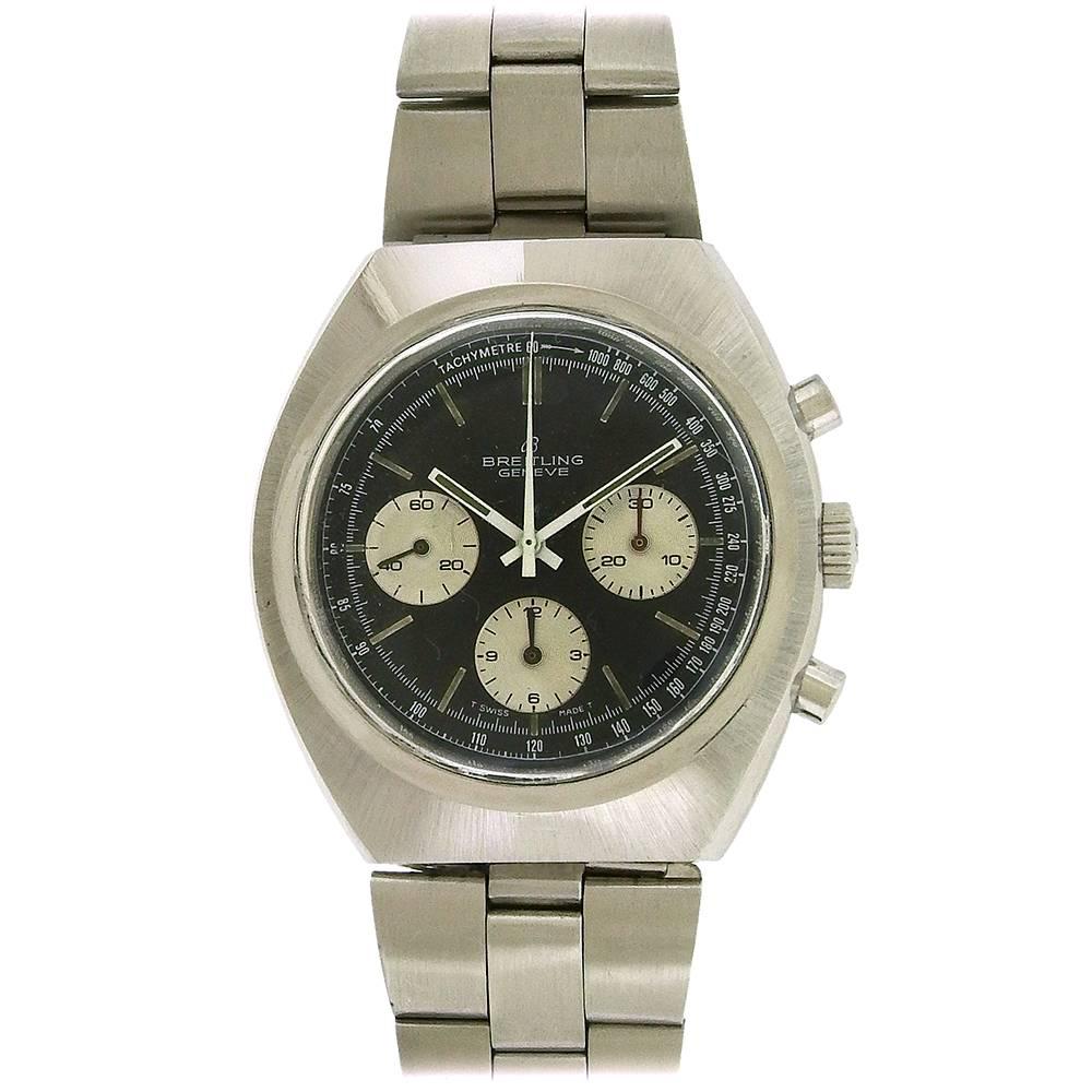 Stainless steel vintage Breitling chronograph, Ref. 1450, circa 1970's, is a tonneau-shape chronograph with stainless steel added bracelet with flip-lock clasp.  The 43mm x 45mm case has a snapback, matte bezel, black and silver dial with constant