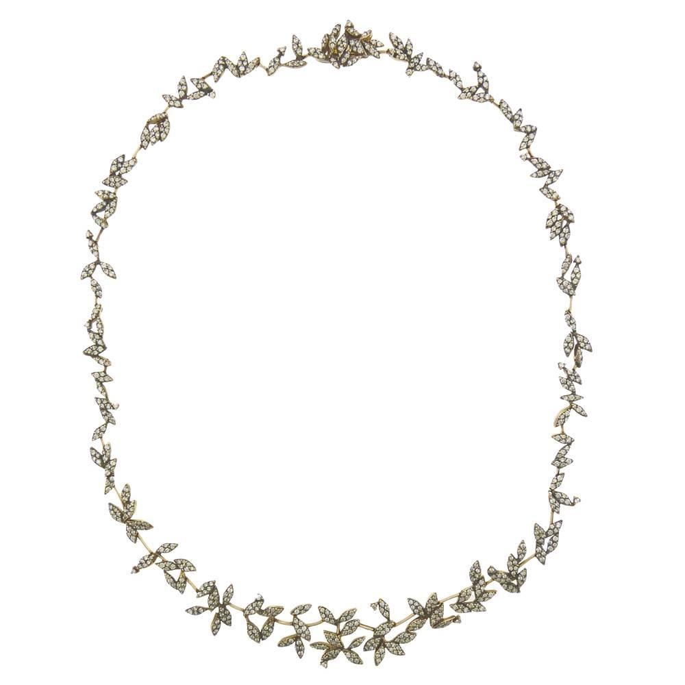 From H. Stern's 'Nature' collection, circa 2008, comes this delicate and sparkling diamond leaf necklace, made by H.Stern with their high karat alloy of white and yellow golds, the surface darkened to highlight the brilliance of the diamonds. The