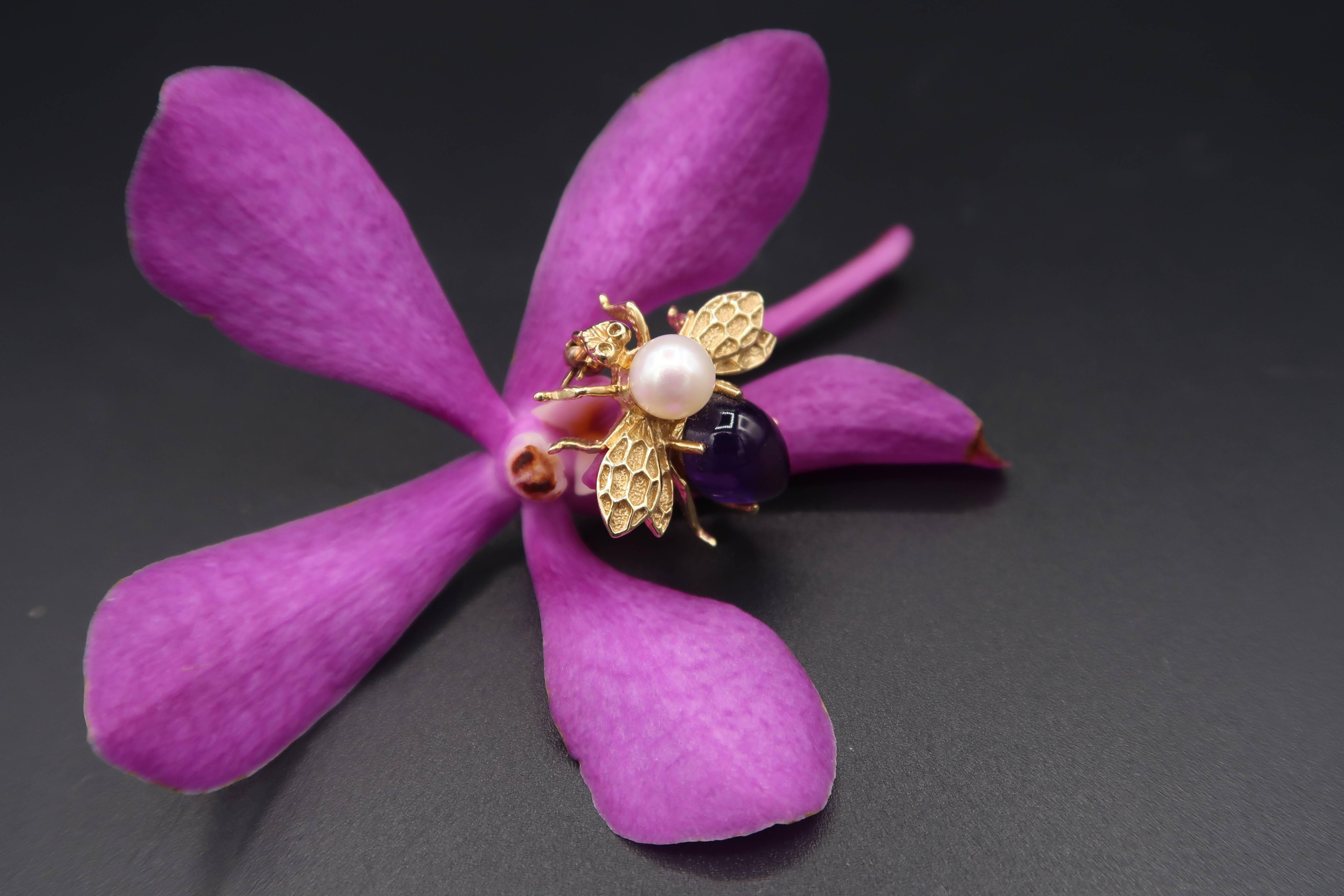 A lovely brooch with minute details of this tiny bee; pollen brushes on its legs, tarsal claws, fore wings, hind wings.

BOON Tiny Bee Brooch with Cabochon Amethyst and Pearl in 18K Yellow Gold
Gold : 4.30g. 18K Yellow Gold
Amethyst : 3.10ct. 
Pearl