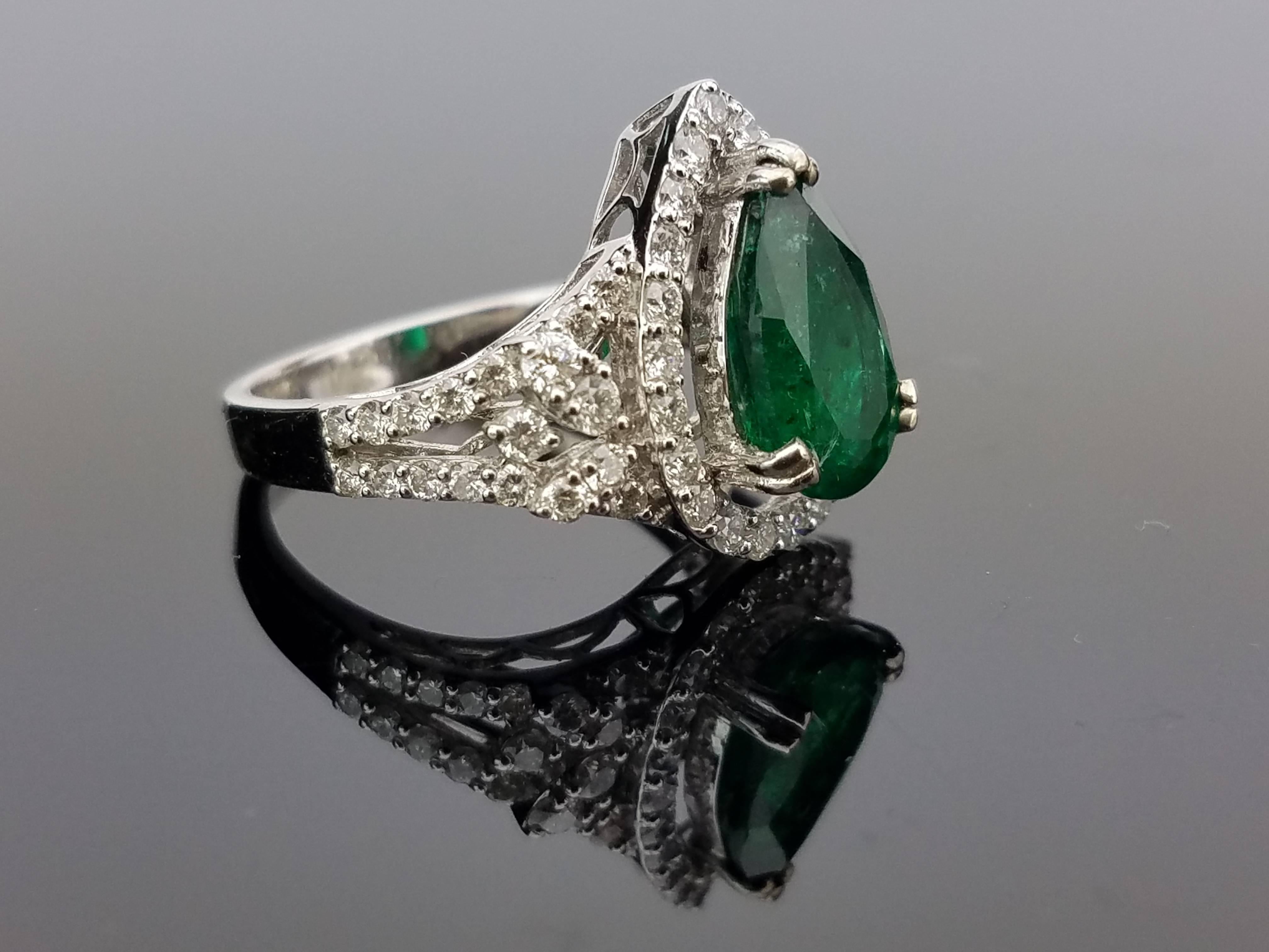 Pear shape Zambian Emerald Ring surrounded with Brilliant Cut Diamond Cluster on 18K White Gold hoop

Center Stone Details: 
Stone: Zambian Emerald
Cut: Pear
Weight: 2.4 carat

Diamond Details: 
Cut: Brilliant (round)
Total Carat Weight: 1.13