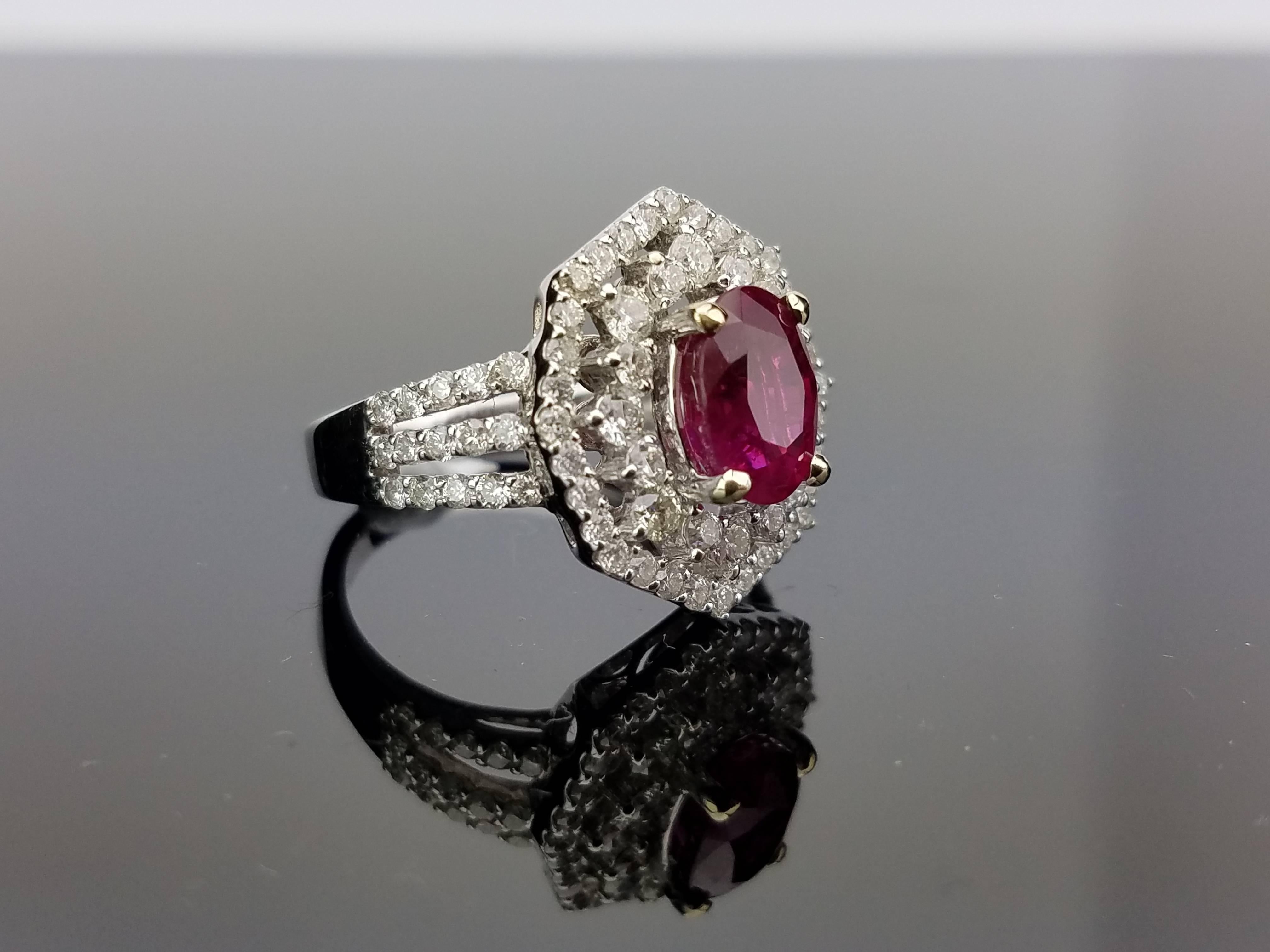 Mozambican Ruby Ring surrounded with Brilliant Cut 2 tier Diamond Cluster on 18K White Gold hoop

Center Stone Details: 
Stone: Mozambique Ruby (heat)
Cut: Oval
Weight: 2.42 carat

Diamond Details: 
Cut: Brilliant (round)
Total Carat Weight: 1.4
