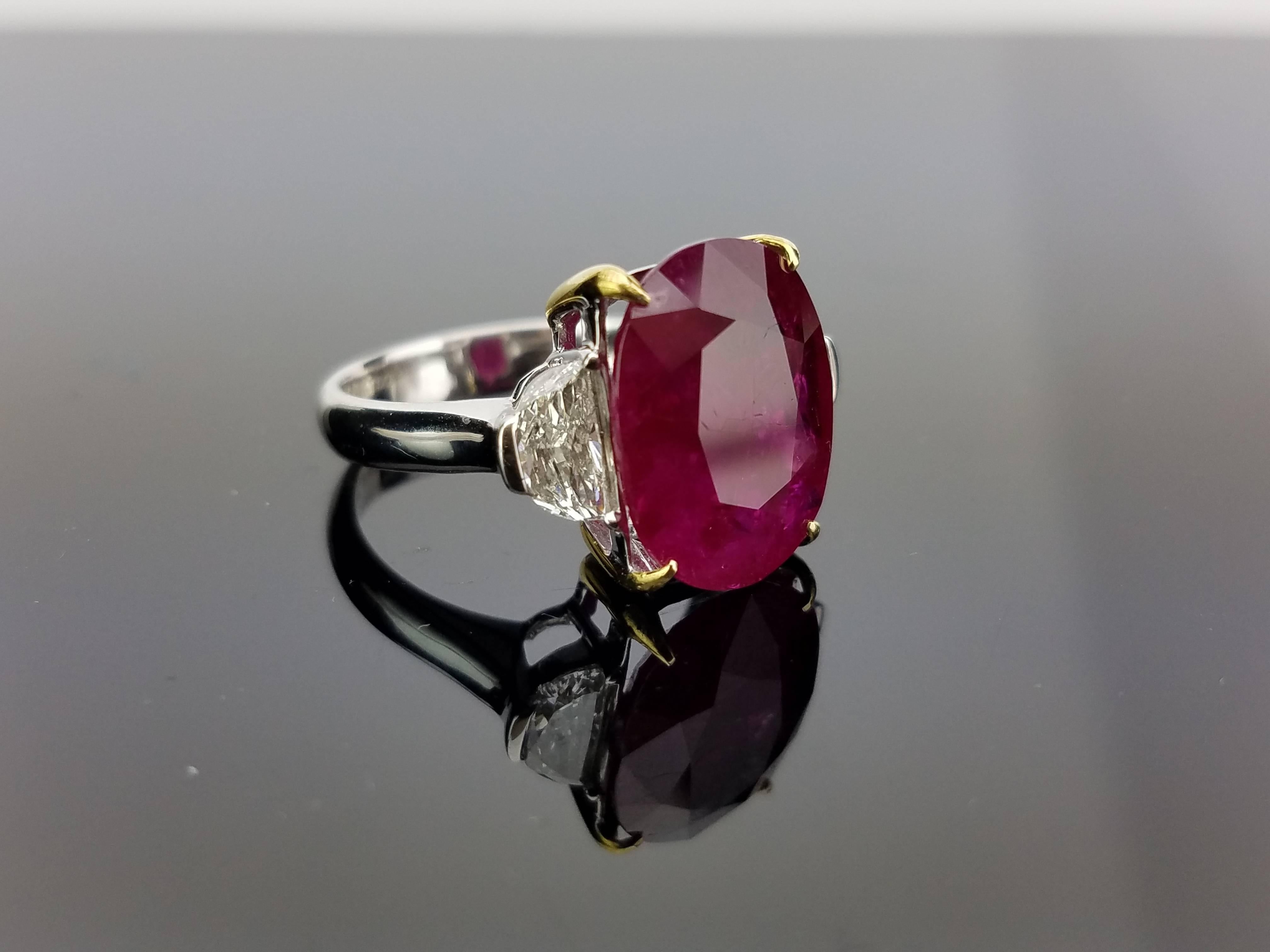 No heat Burma Ruby Ring with 2 half-moon Diamond side stones on 18K White Gold hoop

Center Stone Details: 
Stone: Burma Ruby (no heat)
Cut: Oval
Weight: 8.00 carat

Diamond Details: 
Cut: 2 x Half Moon
Total Carat Weight: 0.83 carat
Quality: VS ,