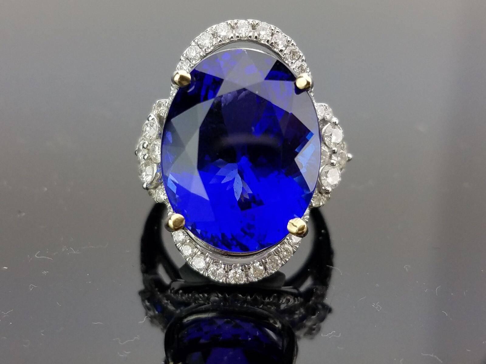 Statement Oval Tanzanite and Diamond Ring on 18K White Gold band

Centre Stone Details:  
Stone: Tanzanite
Cut: Oval
Weight: 18.15 carat

Diamond Details:
Cut: Brilliant (round) 
Total Carat Weight: 1.19 carat 
Quality: VS/SI , H/I 

18K Gold: 8.66