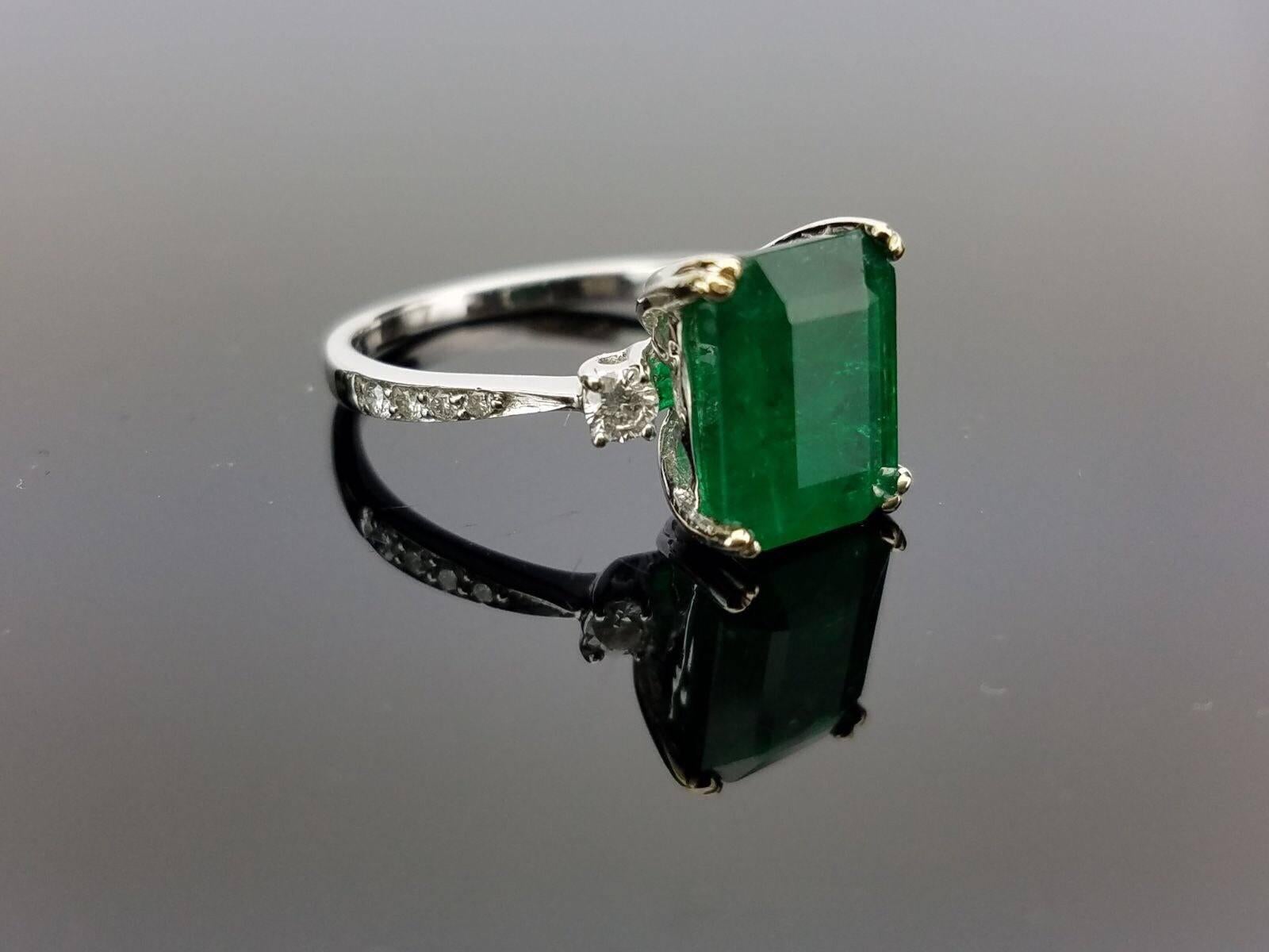 Classic Zambian Emerald with Diamond Ring on 18K Diamond studded White Gold Band

Center Stone Details: 
Stone: Zambian Emerald
Cut: Emerald Cut
Weight: 3.29 carat

Diamond Details: 
Cut: Brilliant (round)
Total Carat Weight: 0.2 carat
Quality: