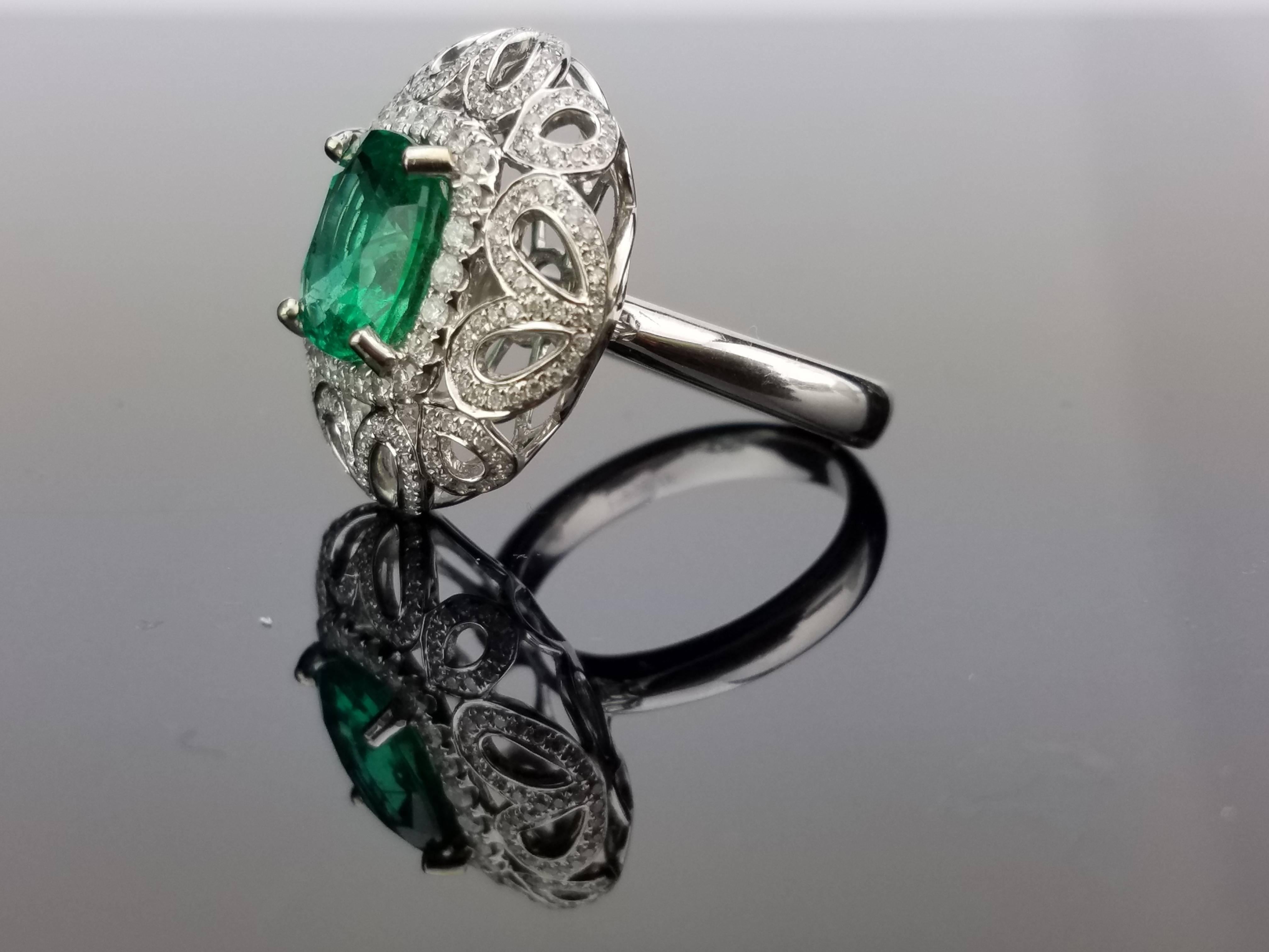 Statement Zambian Emerald Cocktail Ring with Brilliant cut Diamond on 18K White Gold Band.

Center Stone Details: 
Stone: Zambian Emerald
Cut: Cushion
Weight: 3.27 carat

Diamond Details: 
Cut: Brilliant (round)
Total Carat Weight: 1.36