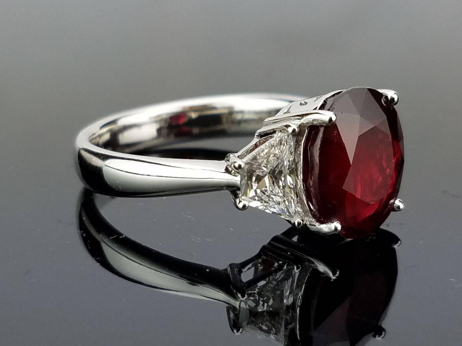 Beautiful, No Heat Mozambique Ruby (very few inclusions) Ring with 2 Trapeze Diamond Side Stone, set in 18K Gold.

Stone Details: 
Stone: No Heat Mozambique Ruby
Cut: Oval
Carat Weight: 4.05

Diamond Details:
Cut: Trapeze
Total Carat Weight: