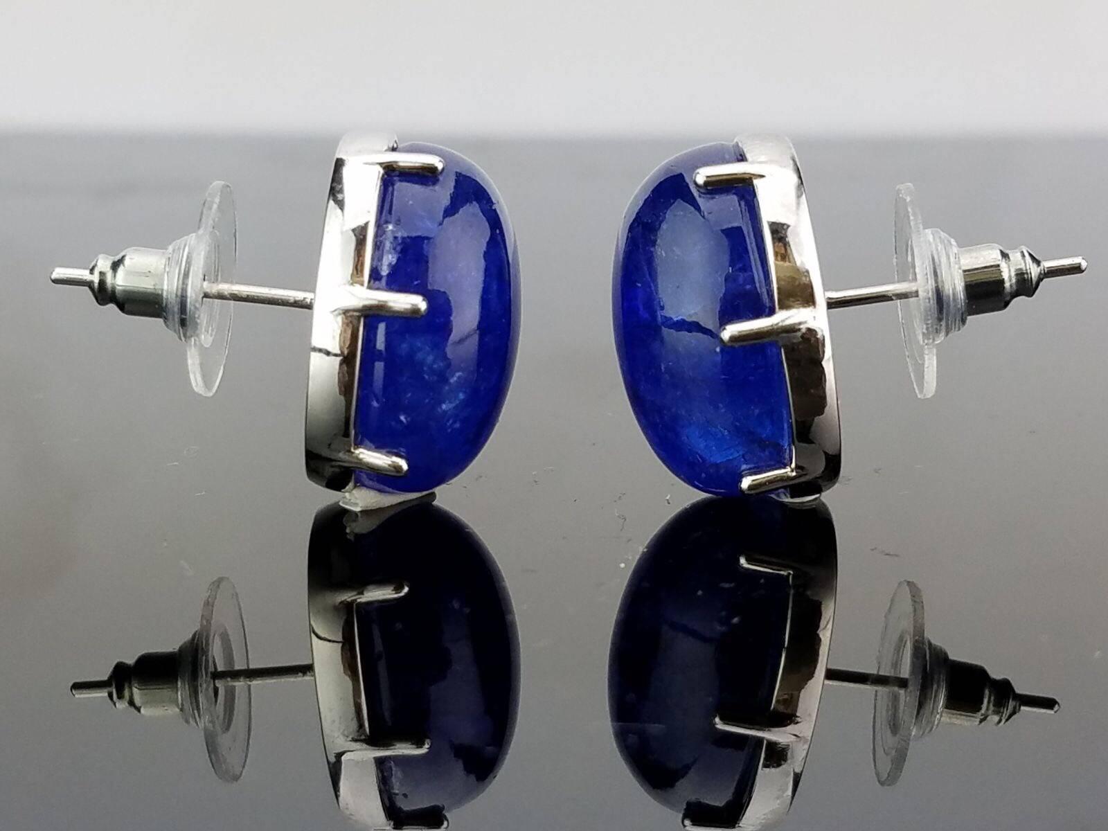 Simple  and Elegant Tanzanite Cabochon Studs, mounted in 18K White Gold

Stone Details: 
Stone: Tanzanite
Cut: Oval, Cabochon
Carat Weight: 48.19 carat

18K Gold: 6.34 grams 

Can provide certificate upon request. 
Can provide cleaning/re-polish