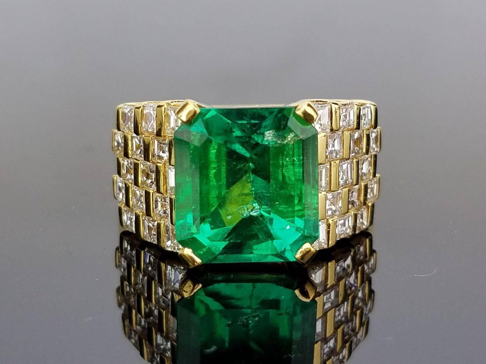 Beautiful Colombian Emerald and Diamond Ring set in 18K Gold 

Stone Details: 
Stone: Colombian Emerald
Cut: Emerald Cut
Carat Weight: 5.61 Carat

Diamond Details:
Cut: Princess
Total Carat Weight: 1.82
Quality: VS/SI , H/I

18K Gold: 11.73 grams