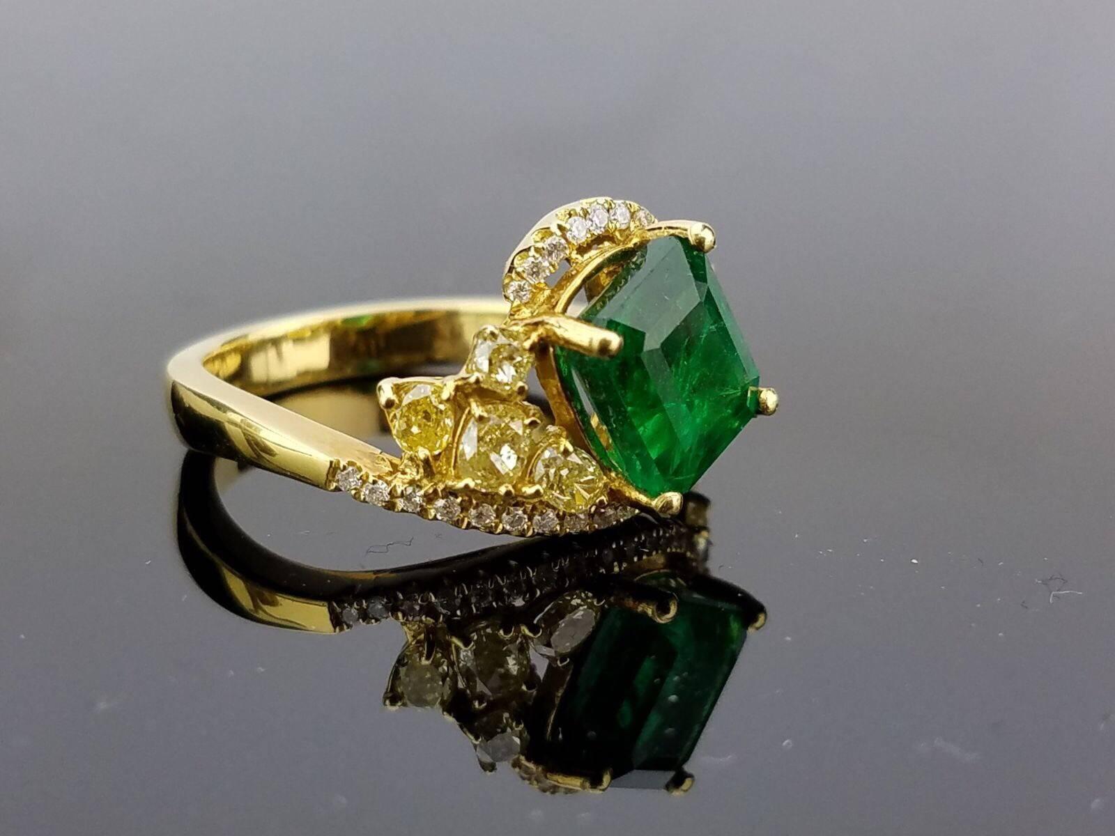 Unique combination of yellow and white Diamonds, and Zambian Emerald set in 18K yellow Gold.

Stone Details: 
Stone: Zambian Emerald
Cut: Emerald cut
Carat weight: 2.03 carat

Diamond Details:
Cut: Brilliant (round) / Oval
Total Carat Weight: 0.92