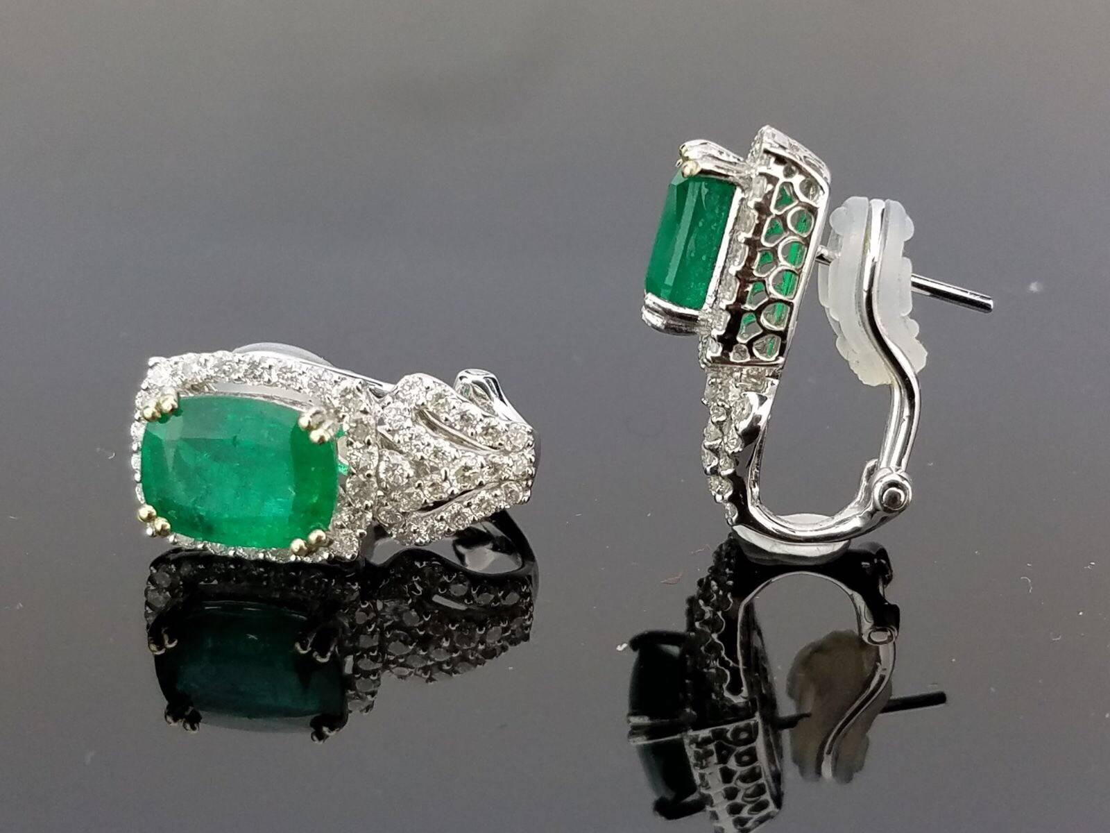 Elegant Emerald earrings with omega backing, embellished with white diamonds all set in 18K white gold. 

Stone Details:  
Stone: Zambian Emerald
Cut: Emerald cut
Carat weight:  4.07 carat

Diamond Details:
Cut: Brilliant (round)
Total Carat Weight: