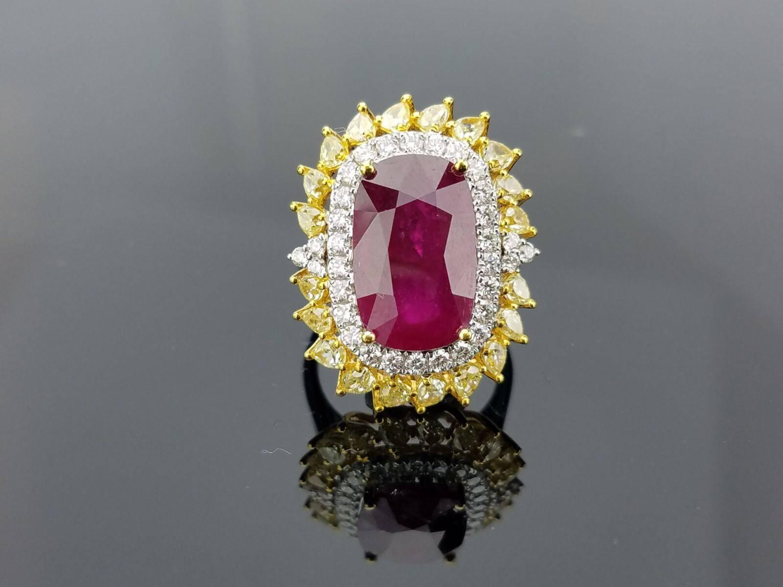 Statement Mozambique Ruby ring with yellow and white Diamond, set in yellow and white gold. 

Centre Stone Details:  
Stone: Burma Ruby
Cut: Oval
Weight: 16.8 carat

Diamond Details:
Cut: Brilliant (round) / Pear 
Total Carat Weight: 2.401 carat