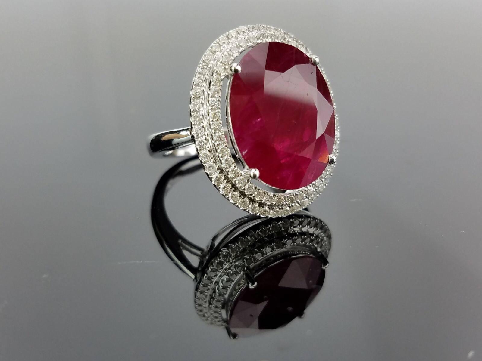 Classic Ruby and Diamond cocktail ring, all set in 18K white Gold. 

Centre Stone Details:  
Stone: Ruby
Cut: Oval
Weight: 8.58  carat

Diamond Details:
Cut: Brilliant (round) 
Total Carat Weight: 0.65 carat 
Quality: VS/SI , H/I 

18K Gold: 5.25