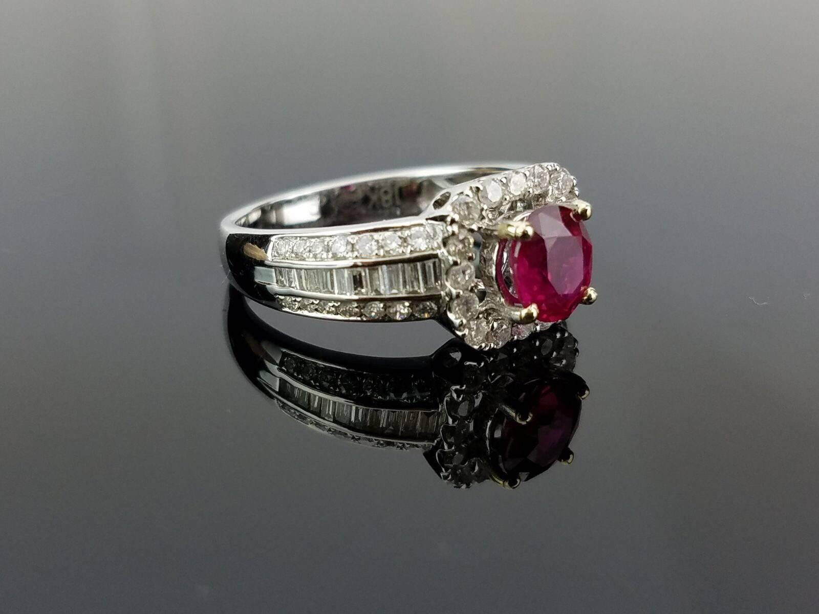 Beautiful and elegant, African Ruby and white Diamond ring all set in 18K white Gold.

Stone Details:  
Stone: African Ruby
Cut: Oval
Carat weight:  1.04 carat

Diamond Details:
Cut: Brilliant (round) / Baguettes 
Total Carat Weight:  0.72