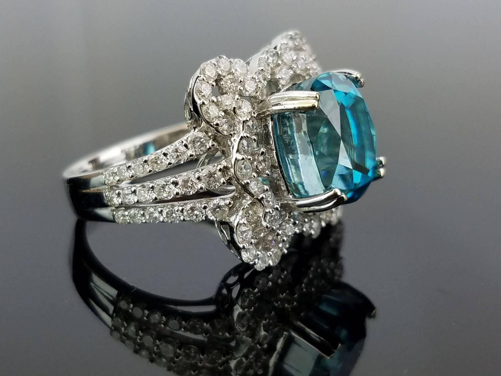 A cocktail ring with a very unique colored stone, blue zircon, set in 18 white gold and diamond.

Stone Details:  
Stone: Blue Zircon
Cut: Oval 
Carat Weight: 9.75 Carat  

Diamond Details: 
Cut: Brilliant cut 
Total Carat Weight: 1.35 carat