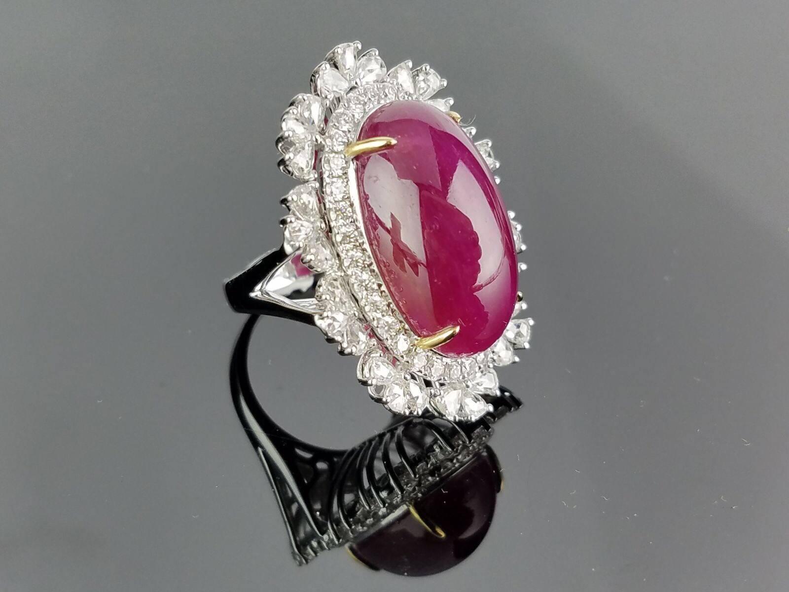 Statement Burmese Ruby (heat) ornamented with rose cut and brilliant cut white Diamonds, all set in 18K white Gold,

Stone Details: 
Stone: Burmese Ruby
Cut: Oval Cabochon
Carat Weight: 20.33 Carat

Diamond Details:
Cut: Brilliant cut / Rose
