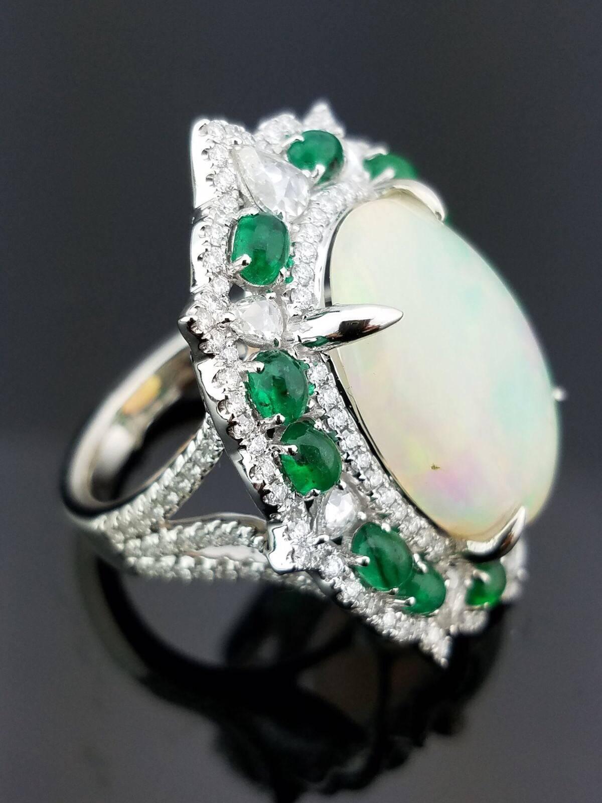 Stone Details:  
Stone: Opal
Cut: Oval Cabochon 
Carat Weight: 10.66 Carat  

Stone: Emerald
Cut: Oval Cabochon
Carat Weight: 2.33 Carat 

Diamond Details: 
Cut: Rose cut
Total Carat Weight: 0.96 carat 
Quality: VS/SI , H/I  

18K Gold: 14.36 grams 