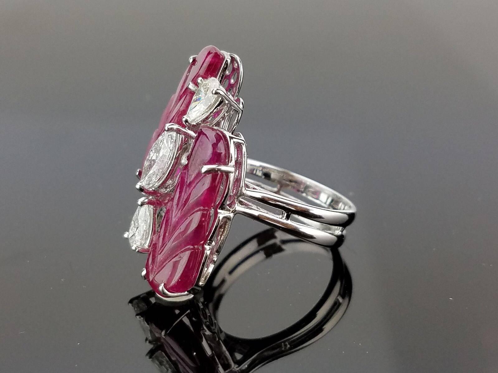 Beautiful cocktail ring, with 2 identical carved Ruby with pear/marquise shaped White Diamond cocktail ring, all set in a white 18K gold. 

Stone Details: 
Stone: Ruby 
Carat Weight: 8.43 Carat

Diamond Details:
Total Carat Weight: 1.19
