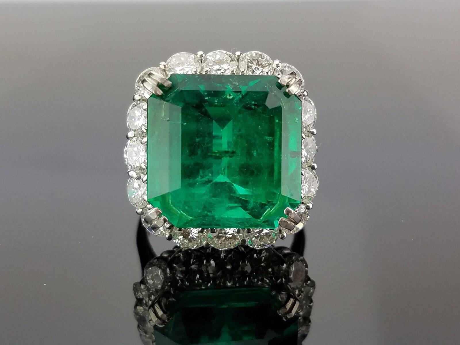 A high quality, lustrous emerald with very few inclusions and insignificant oil, and diamond (each piece weighing around just above 20 cents) cocktail ring, set in platinum.

Stone Details:  
Stone: Colombian Emerald
Cut: Emerald Cut
Carat Weight:
