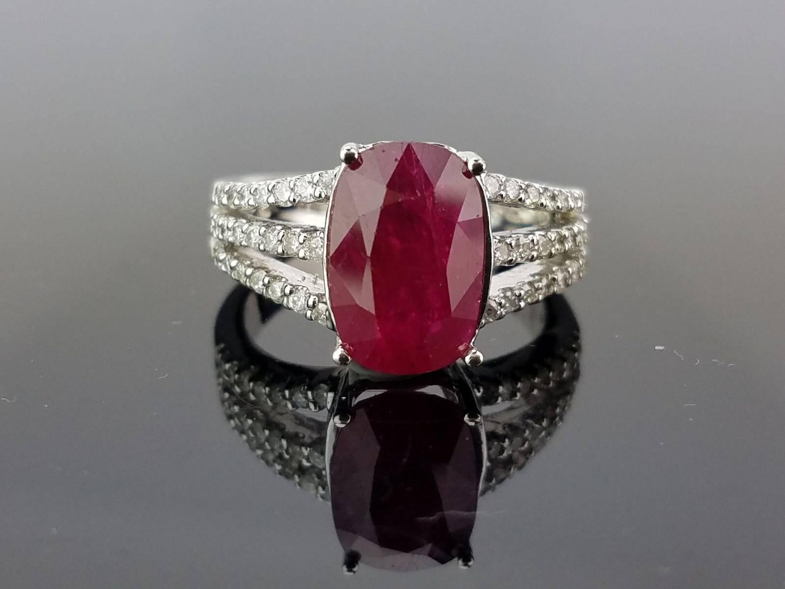 An elegant oval shaped ruby ring, with diamonds all set in 18K white gold

Stone Details: 
Stone: Ruby
Carat Weight: 5.59 carat

Diamond Details:
Total Carat Weight: 0.79 carat
Quality: VS , H/I

18K Gold: 7.7 grams