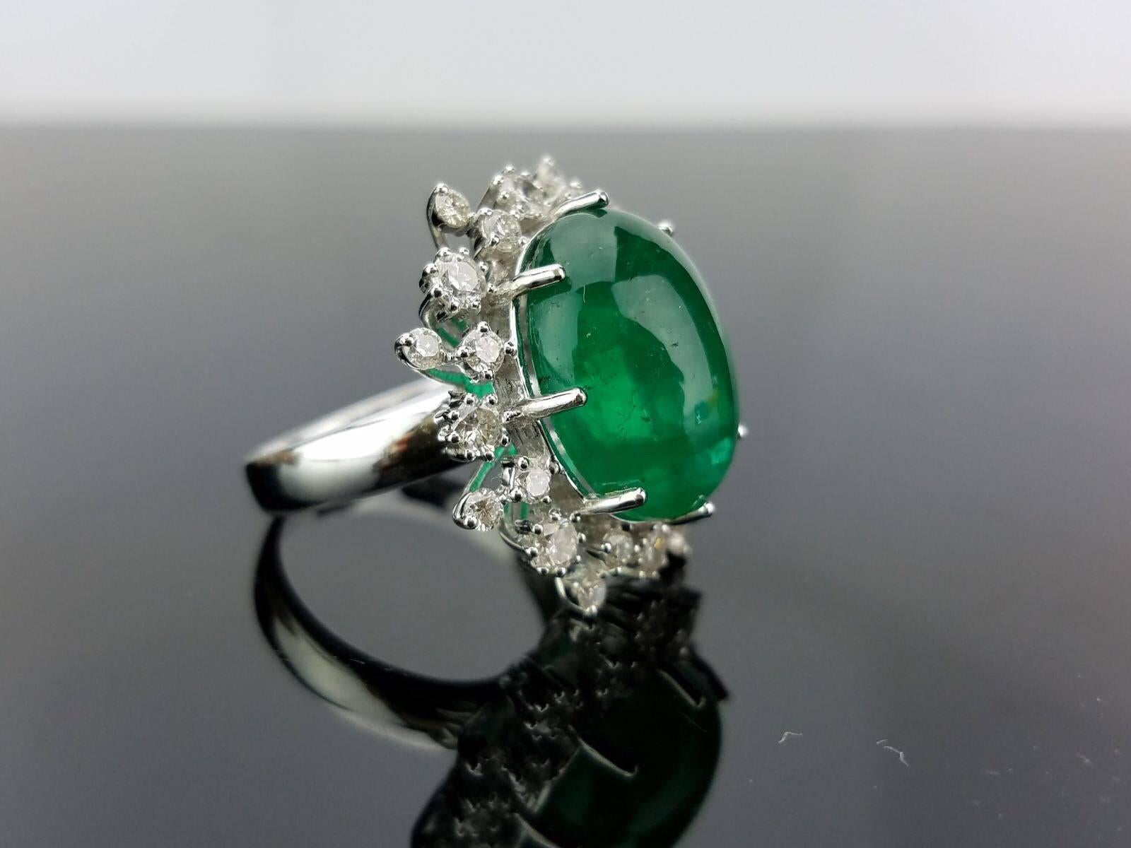 An elegant cocktail ring using a beautiful Emerald Cabochon centre stone surrounded with White Diamond, all set in 18K white gold. Currently a ring size US 6, but we can resize the ring for you without additional cost. 

Stone Details: 
Stone: