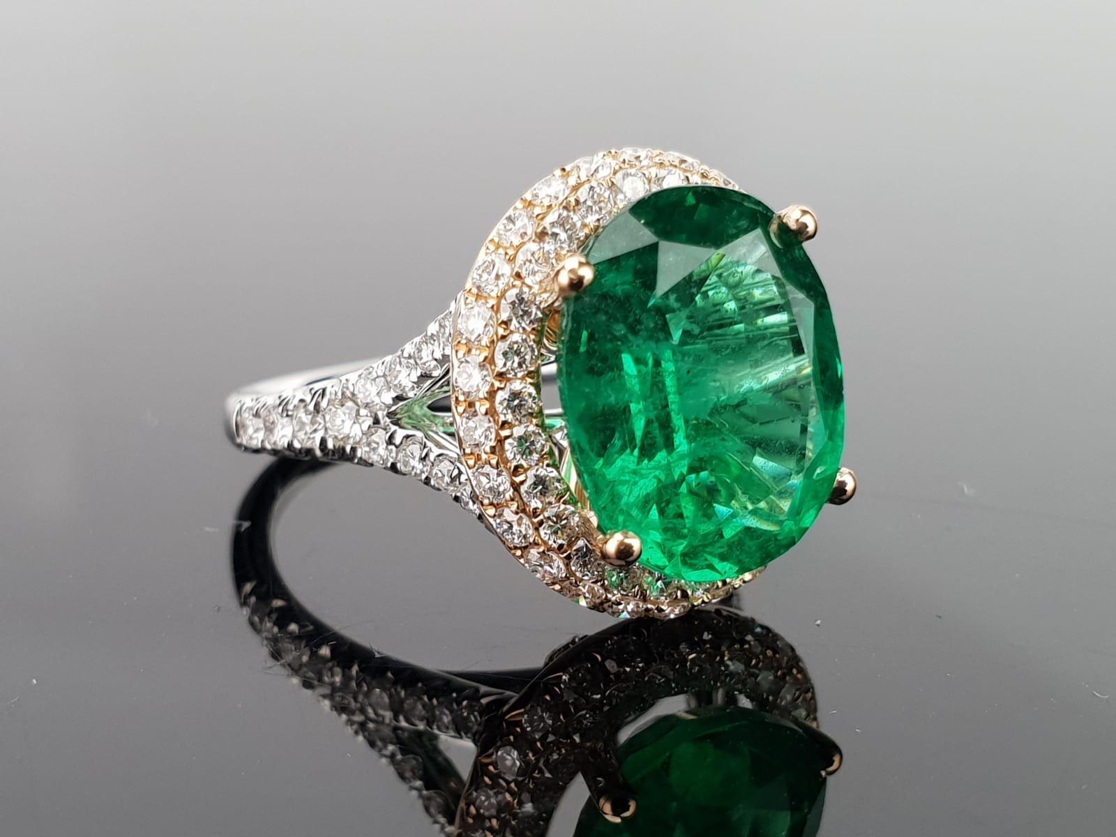 An elegant and simple cocktail ring using a 5.46 carat round cut Zambian Emerald centre stone, with 1.16 carat, 92 pieces of brilliant cut diamonds sorrounding it, all set in 18K white and rose gold.   

Stone Details: 
Stone: Zambian Emerald 
Carat