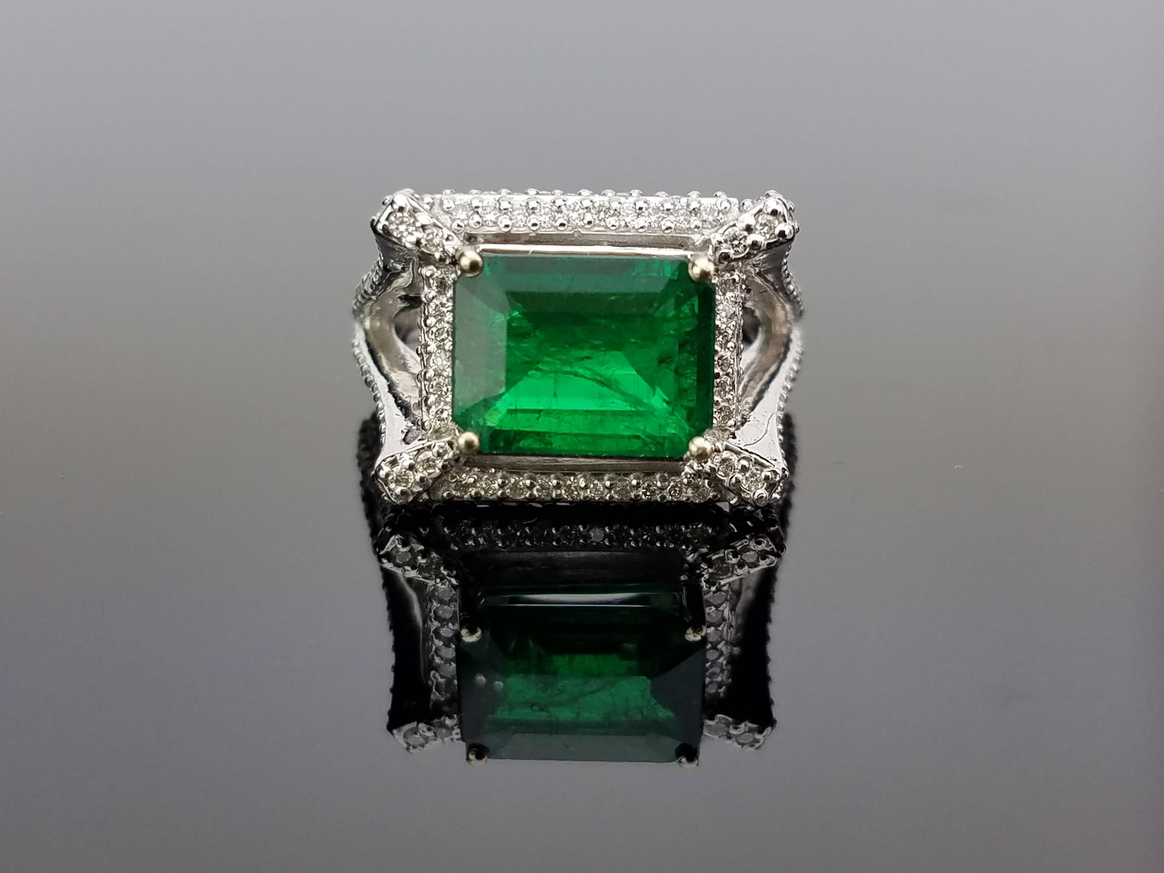 Zambian Emerald Ring with pavé set Diamond on 18K White Gold hoop

Center Stone Details: 
Stone: Emerald
Cut: Emerald Cut
Weight: 3.16 carat 

Diamond Details: 
Cut: Brilliant (round)
Total Carat Weight: 1.17 carat 
Quality: VS/SI , H/I 

18K Gold: