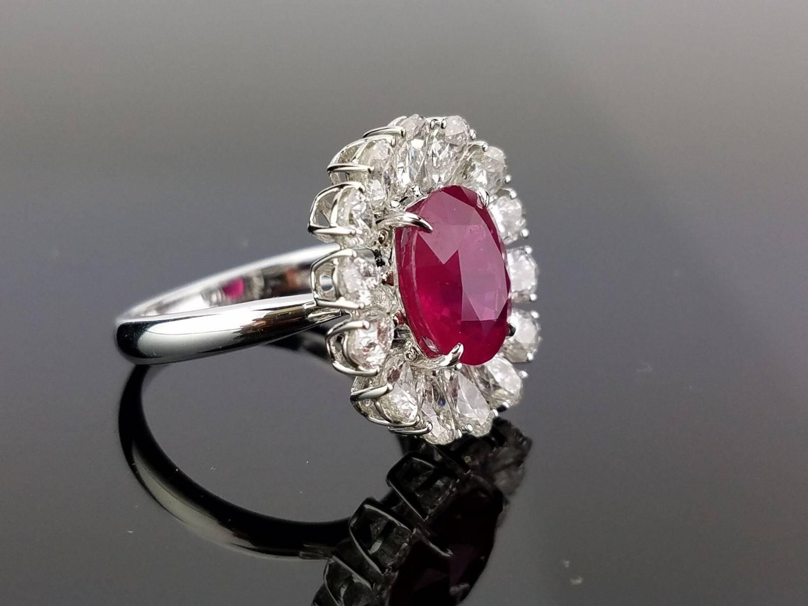 A beautiful oval heated Burmese Ruby and pear-shaped White Diamond cocktail ring and studs suite set, all set in 18K white gold. 

Ring:
Stone: Burma Ruby, 4.10 carat
Diamond: VS / H,I , 2.54 carat
18K Gold: 5.32 grams

Earrings:
Stone: Burma Ruby,