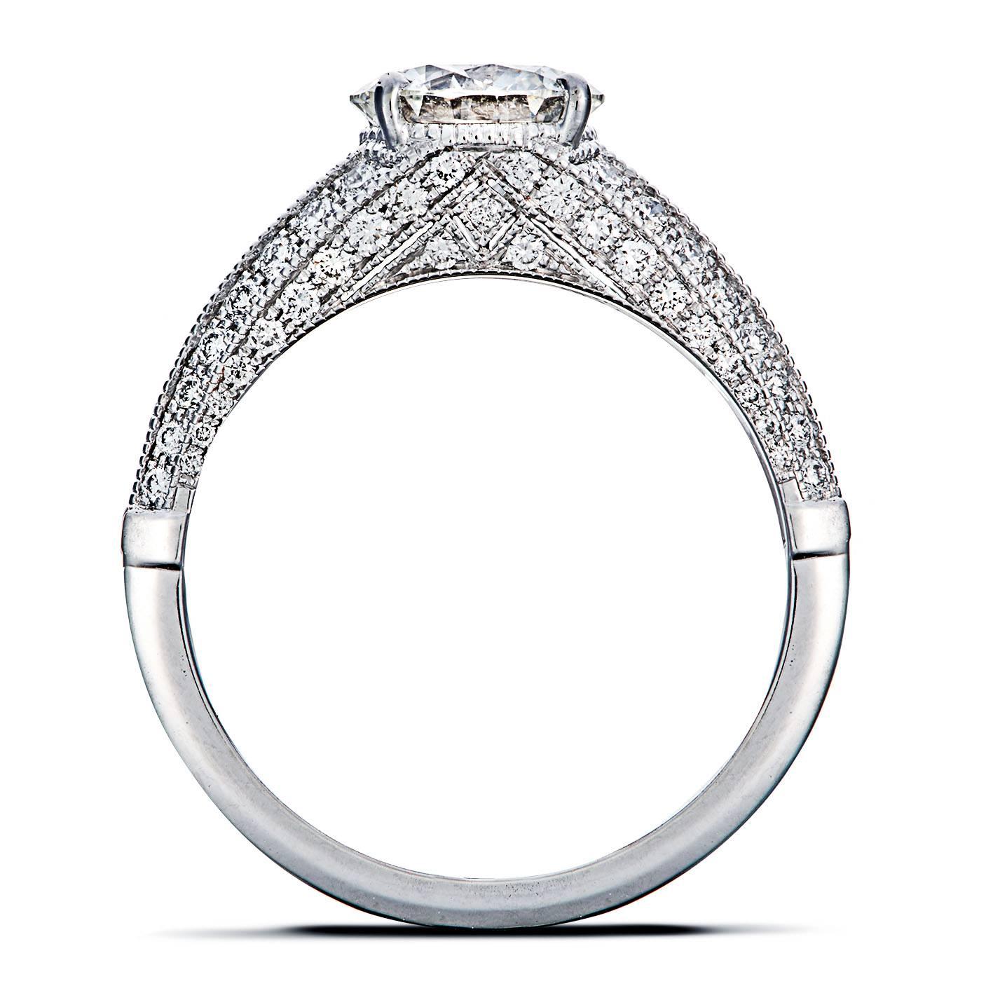 The Raquel ring is mounted in 18k white gold showcases a GIA certified 1.35 carat H VS1 brilliant-cut diamond, highlighted by pavé  round diamonds (FVS), for a total weight of 0.80 carats. The ring is set with a miligree setting technique as an Art