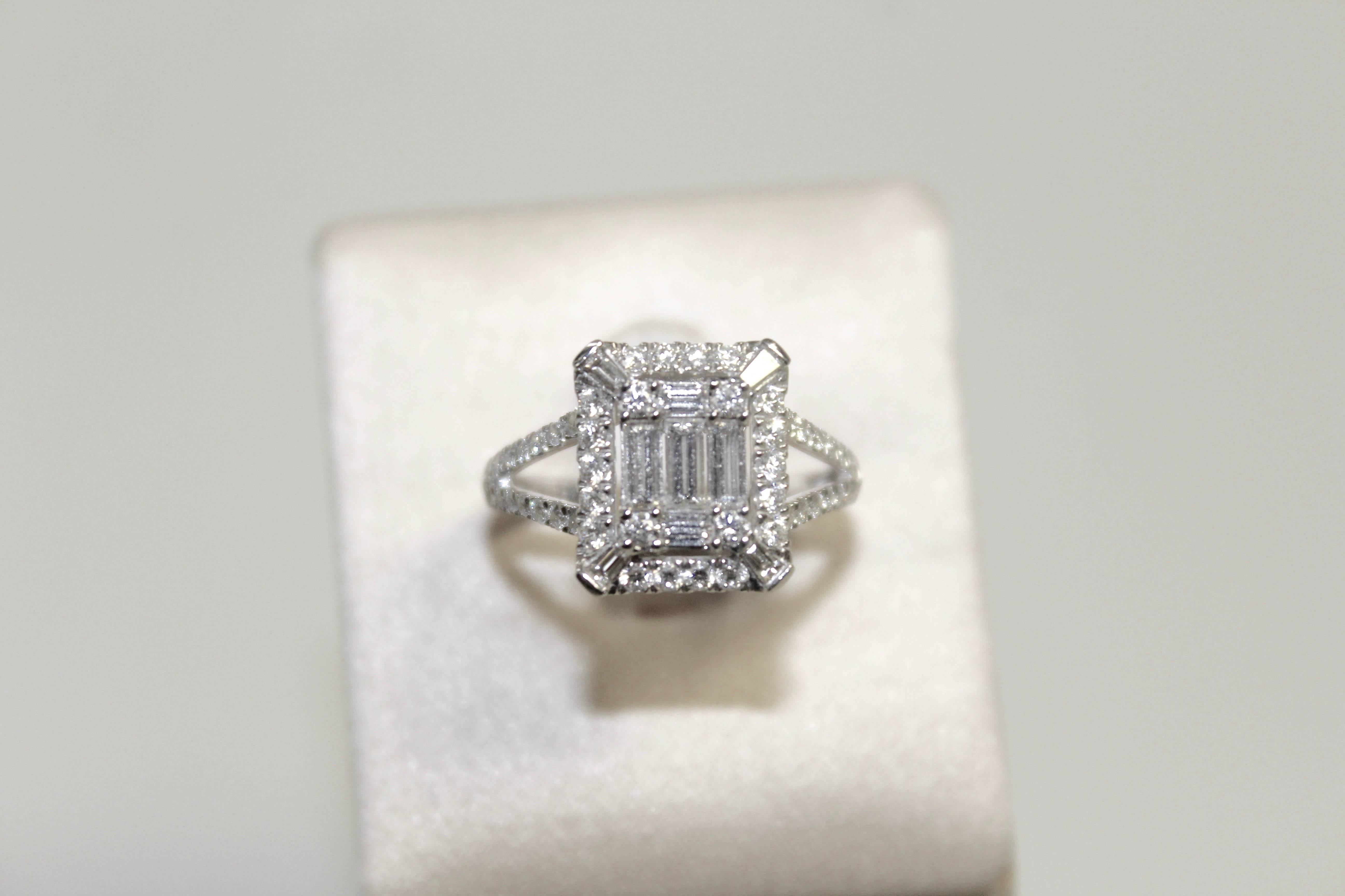 The Clarence ring mounted in 18k white gold showcases  a center motif set with 5 E VVS baguette-cut diamonds for a total of 0.24 carat, highlighted by a pavé setting with round diamonds (FVS) weighing a total of 0.43 carat. Designed by Valerie