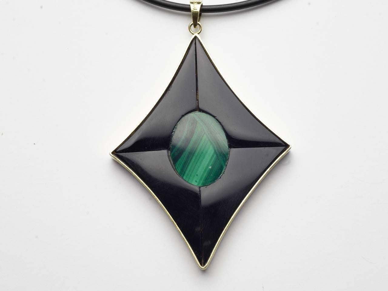 14kt gold pendant inset with coral on one side and malachite element on the other. Suspended on a silk cord. See additional photo. 14kt. 585.
