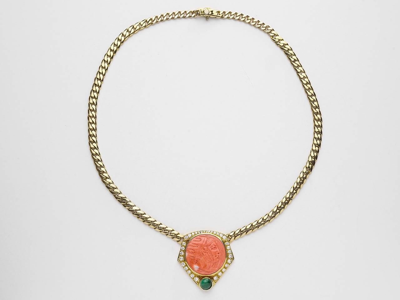14kt. Gold snake chain, centering a diamond bezel set carved coral element with emerald accent.n Diamond weight approximately 1.25 carats.