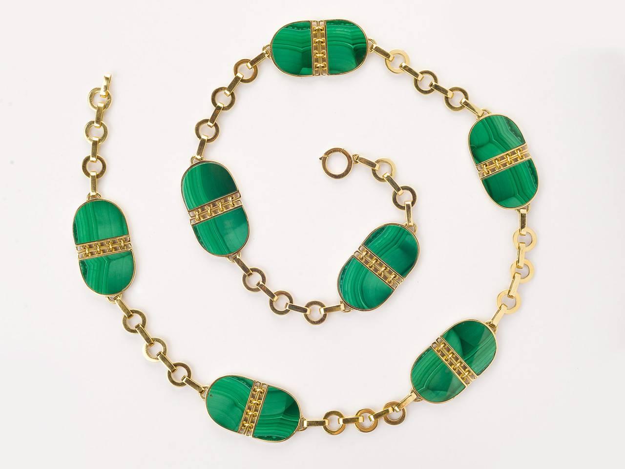 18kt gold chain necklace set with double-sided malachite plaques with gold work centers. Signed 750 with maker's mark.