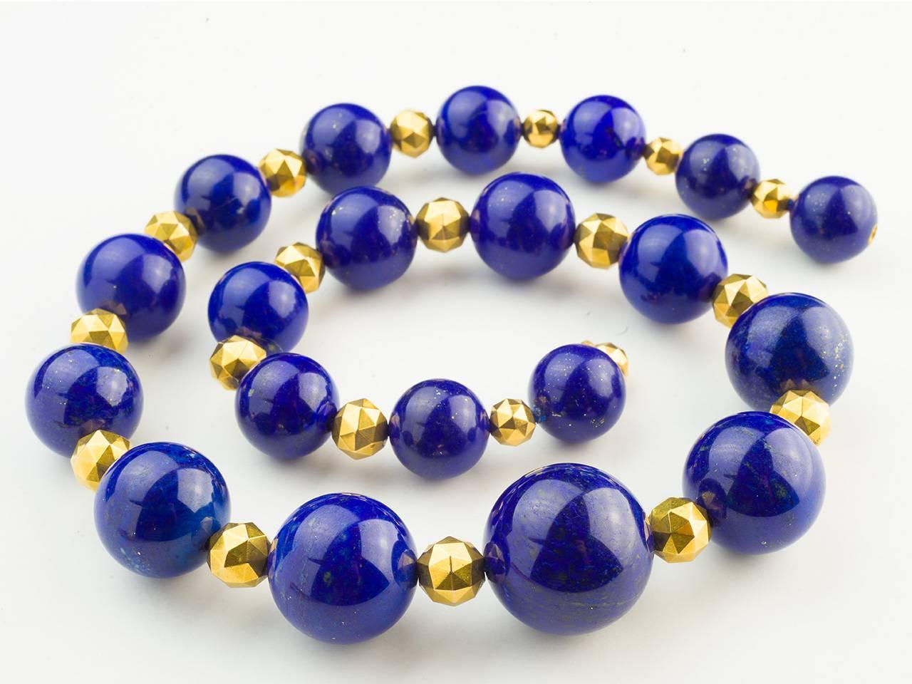 18k gold and lapis bead necklace by Carvin French, composed of 20 lapis beads, ranging in size 16-40mm. Maker's mark.