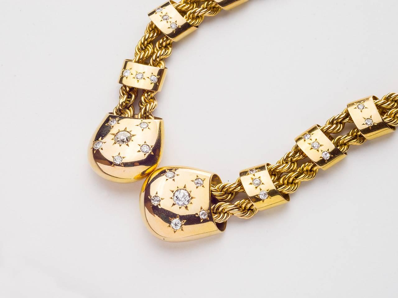 18kt. Gold necklace consisting of rope chain secured by diamond studded bands, centered by gold and diamond boules. Signed BOUCHERON PARIS.