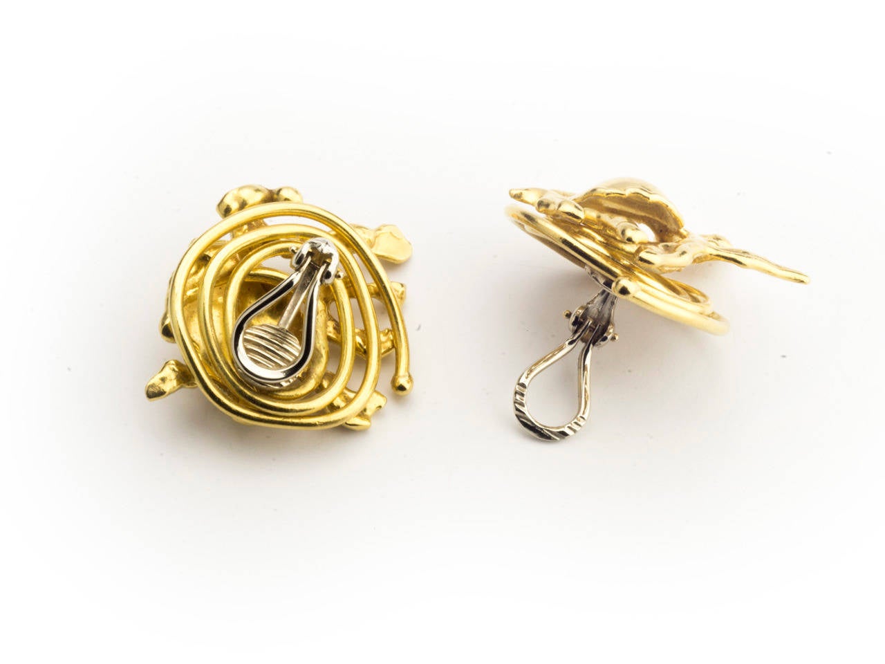 22 kt. gold earclips by Jean Mahie. Signed JM.