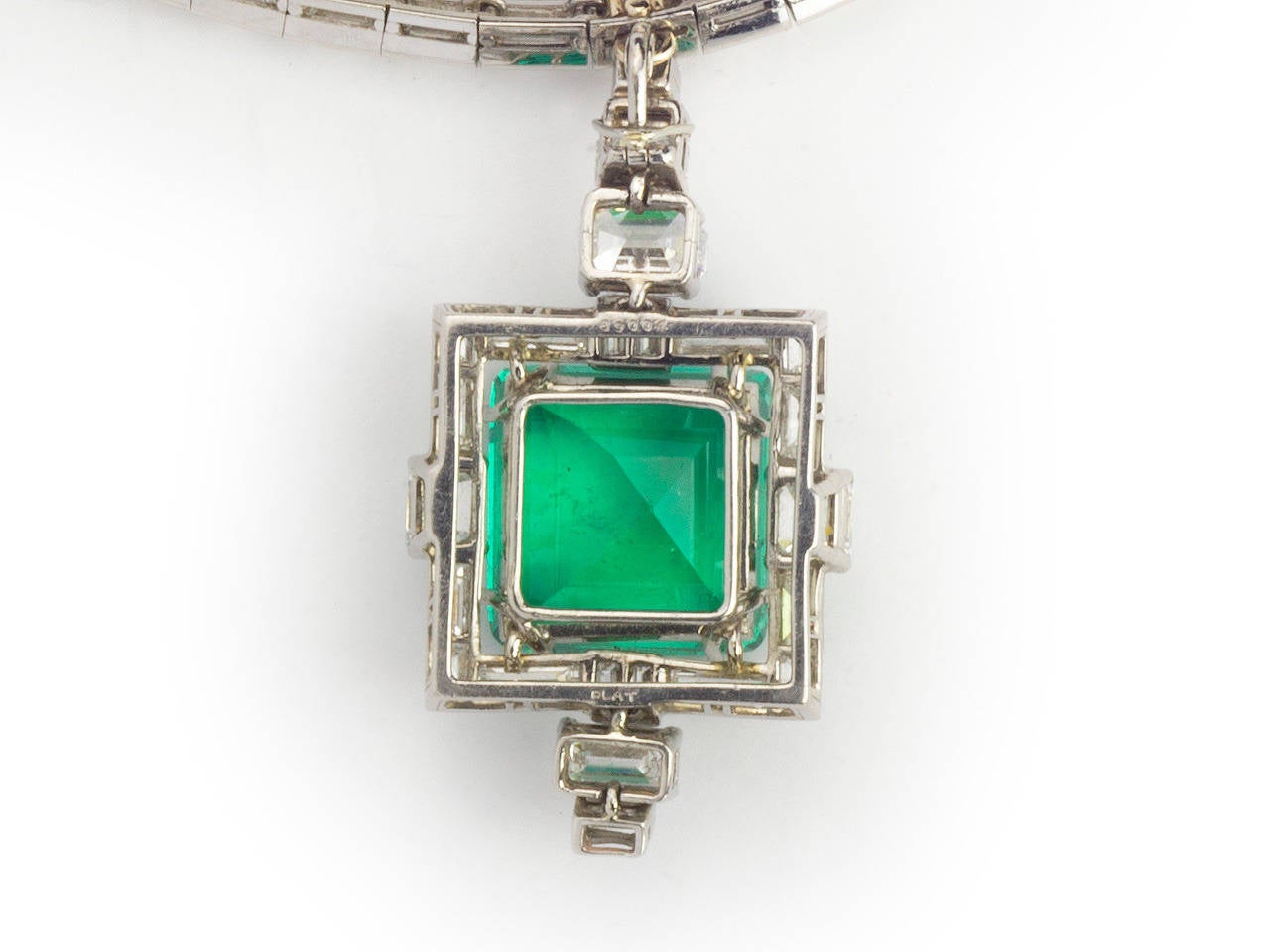 Platinum and diamond line necklace, suspending a detachable emerald and diamond pendant. Emerald is step-cut and approximately 13.00 carats.It  is accompanied  with a GIA report stating the emerald to be natural Columbian. Indications of minor