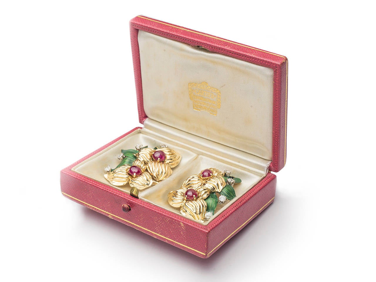 18k gold Flower earclips, with ruby cabochon, round diamonds and enamel leaves. Signed CARTIER. In fitted box with brooch fitting.

