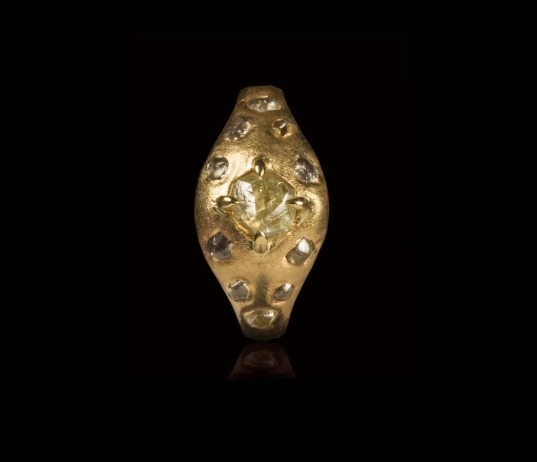 1.25 carat natural Yellowish and 1.13 carat natural Greyish rough diamonds in a handmade one-of-a-kind 14 karat gold ring.

A combination of a large uncut rough yellowish and smaller greyish rough diamonds set into a handmade chunky gold