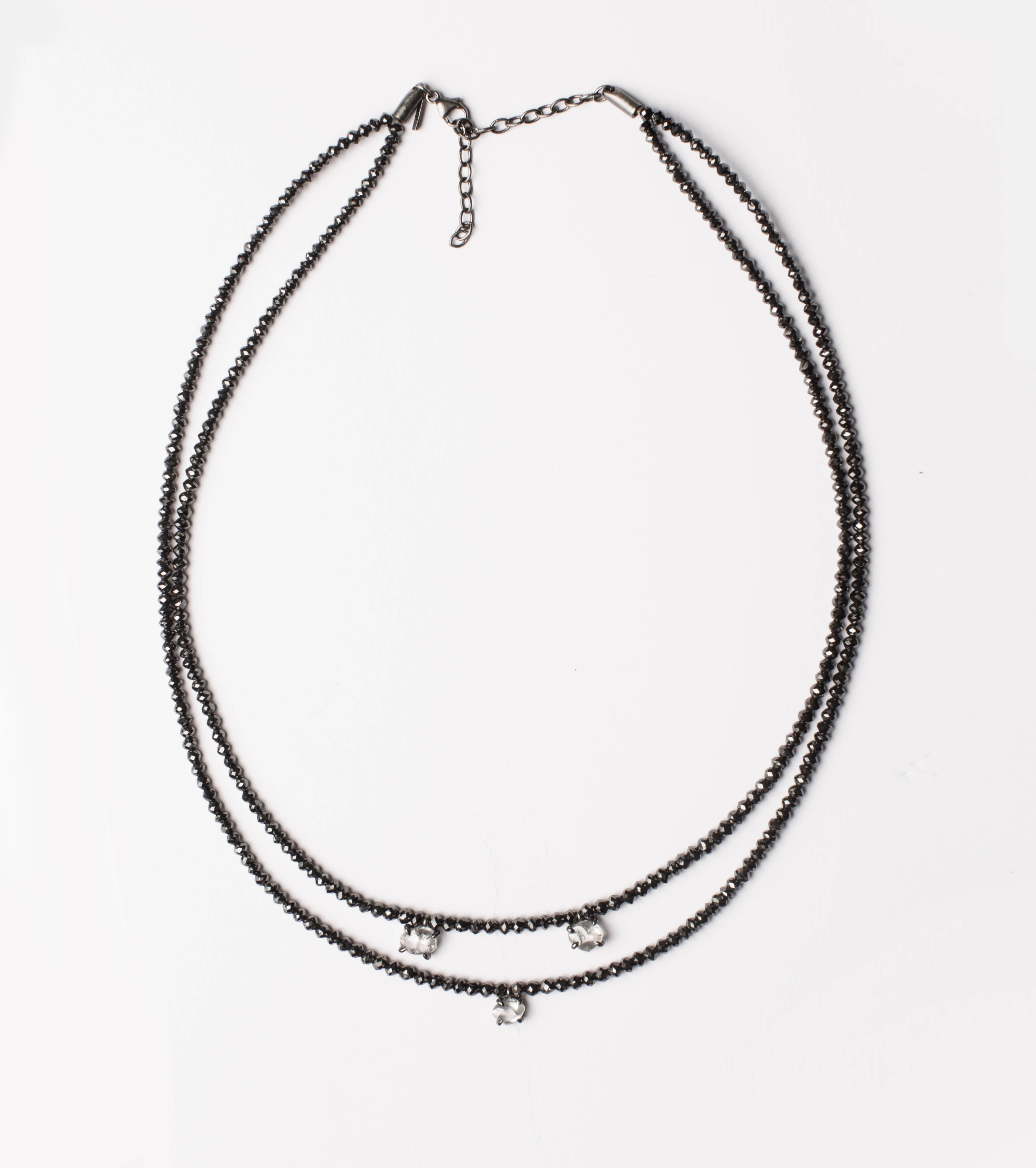 3.39 ct. natural whitish round rough diamonds adorns two strings of 65.27 ct. black facetted diamonds set as one gorgeous necklace. A new elegant, yet understated, way of wearing diamonds.

Every rough diamond from Roughdiamonds dk has been