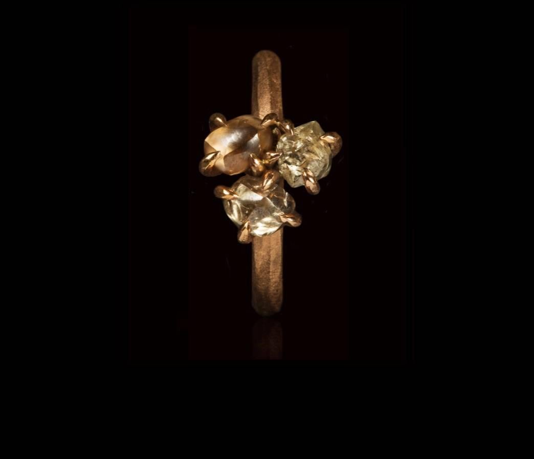 A trio of 2.45 carat natural rough, uncut light brown, champagne and greyish diamonds set in a brushed handcrafted 14 karat rose gold ring.

Every rough diamond from Roughdiamonds dk has been personally handpicked by Maya Bjørnsten right before it