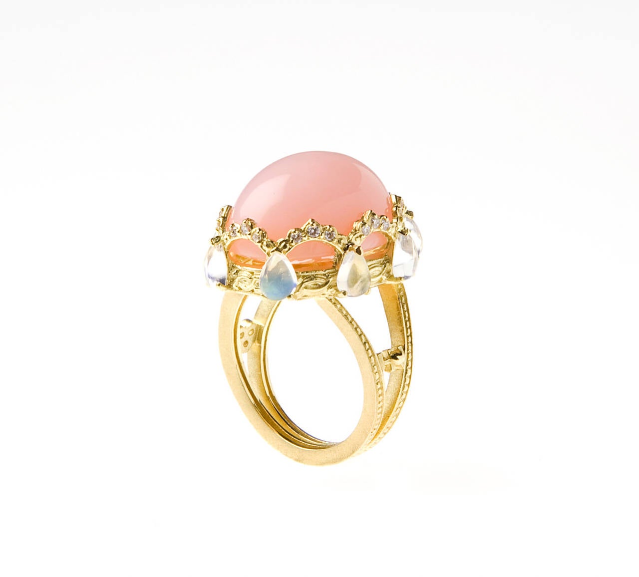18K Gold Ring with Pink Peruvian Opal Center, Moonstones and Diamonds

Center stone is a 18.00 ct.Pink Peruvian Opal Center, 20 x 15mm

Surrounding the Center Stone are 0.22ct.G color VS quality diamonds and eight Pearshape Rainbow Moonstones