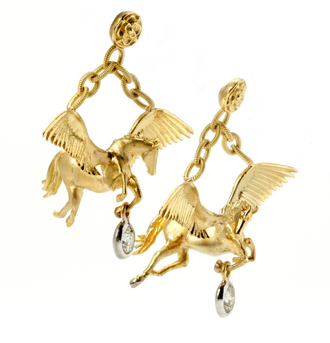 18k Gold 3D Pegasus Earrings with single drop diamond on each

0.50 ct.'s G Color, VS Quality Diamonds Bezel Set.

The wings, head, legs & tail of the Pegasus are full of detail and is hung by several loop chains

Jumbo Backs are used to hold