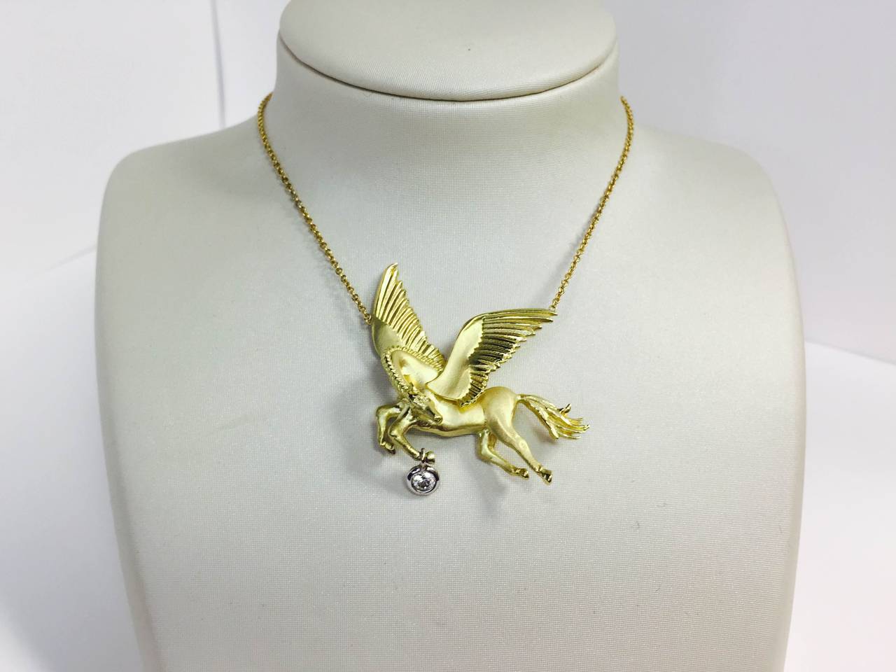 18K Gold Necklace with Pegasus and Diamond Drop

The Pegasus is one of the best known creatures in Greek mythology. 

Comes attached to the 16 inch chain.

0.25 ct G Color, VS Clarity Diamond is bezel set, hanging from the leg of the Pegasus.