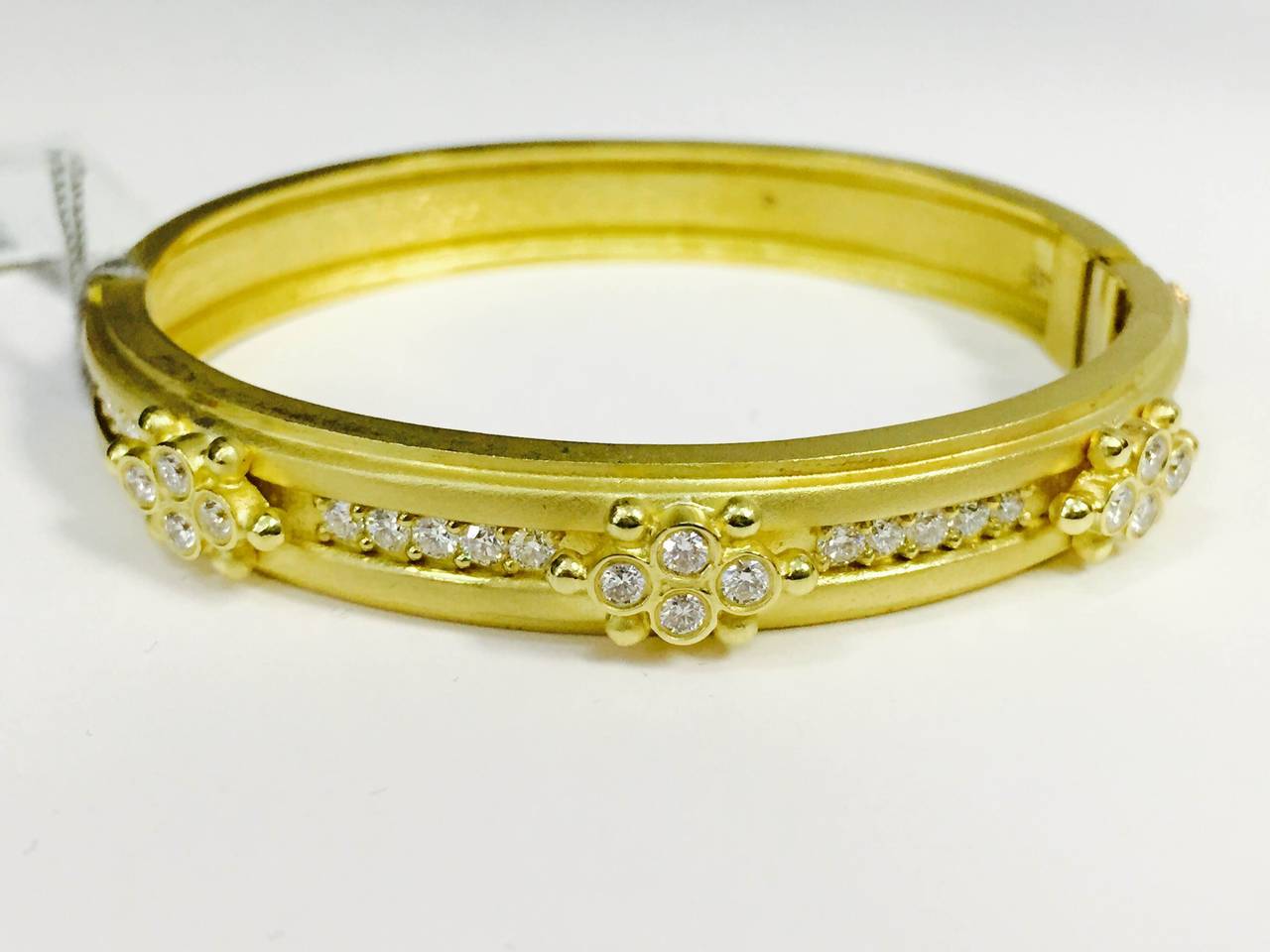 18k Gold & Diamond Bangle bracelet

1.70 ct.'s of G Color, VS Quality Diamonds

Opens and closes with our push button technique- From the Pink Diamond Heart 

Size- 6 3/4 can be sized up or down free of charge.

Last photo with 3 bangles is